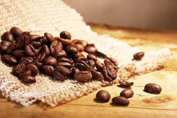 coffee beans on sacking on wooden table