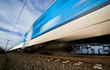 Fast train passing under a bridge on a lovely summer day