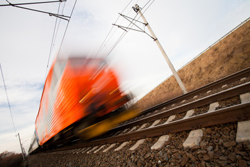 Fast train passing under a bridge on a lovely summer day