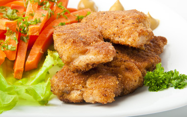 chicken fried in breadcrumbs with vegetables