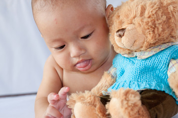 Little boy playing with a bear