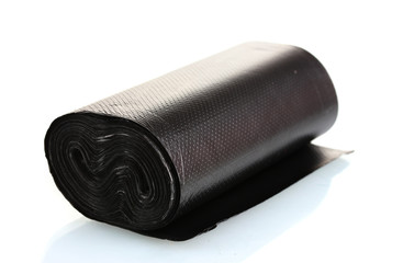 Roll of black garbage bags isolated on white
