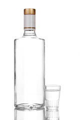 Bottle of vodka and wineglass isolated on white