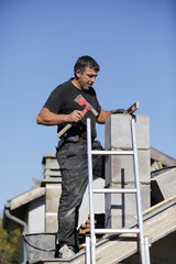 Tradesman building a chimney stack