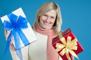 Happy caucasian blond woman demonstrating gift boxes