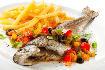 Fish dish - roast trout and vegetables on white background