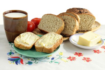 milk,bread and butter with red tomato