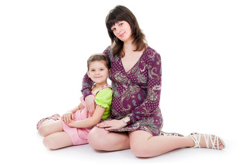 Pregnant mum sits with the daughter, a white background