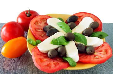 mozzarella cheese with olives,tomatoes and basil leaves
