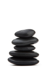 zen stones. Black massage stones stacked, isolated.