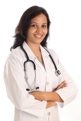 Arms crossed woman doctor against white