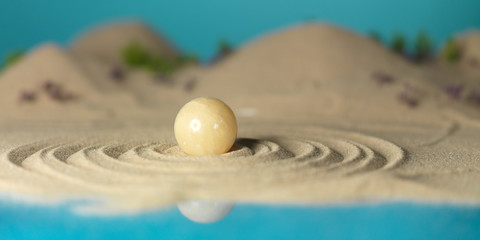 Fototapeta na wymiar yellow quartz sphere in miniature landscape