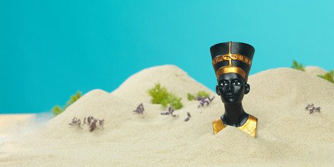 nefertiti egyptian bust in miniature sandy landscape