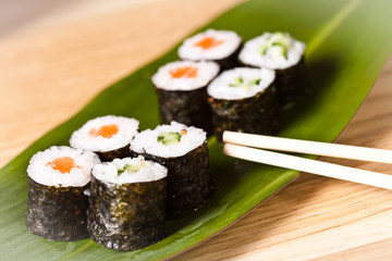 sushi rolls with chopsticks