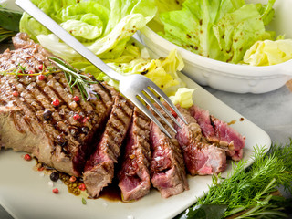 sliced steak with balsamic vinegar and green salad
