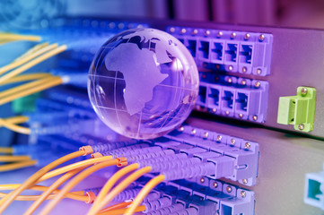 globe with network cables and servers in data center