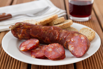 sausage with toasts and glass of wine