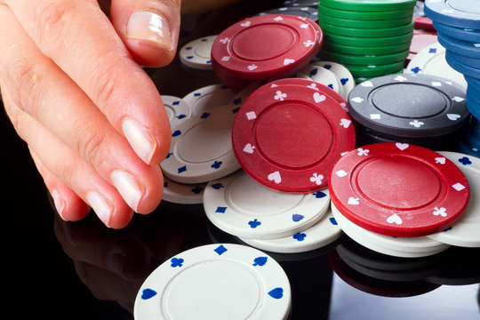 Hand takes stack of poker chips