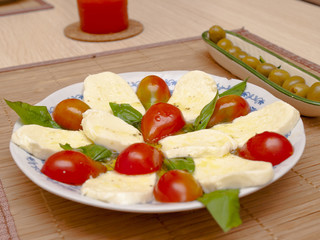 Italian salad with tomatos and mozarella cheese - obrazy, fototapety, plakaty