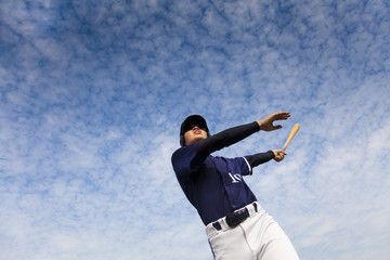 young baseball player taking a swing