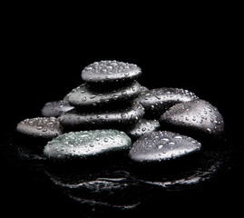 Spa Stones. black shiny zen stones with water drops over black b