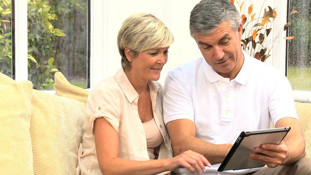 Middle Aged Couple Happy with Their Financial Planning