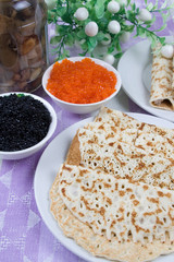 Pancakes with red and black caviar