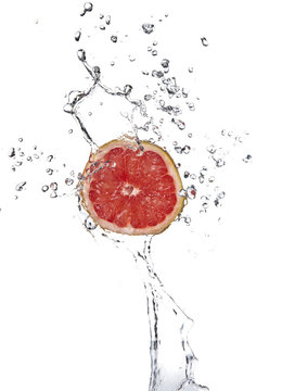 Red grapefruit with splashing water