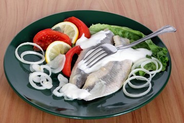 marinaded herrings with cream,onion and salad
