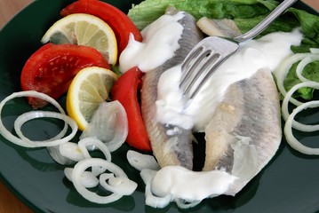 marinaded herrings with cream,onion and salad