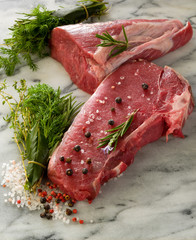 raw porterhouse and tenderloin with mixed herbs juniper berry