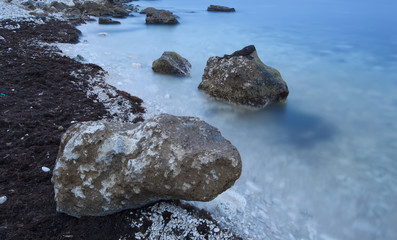 big boulder on the bank of the  blue sea