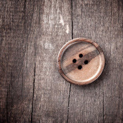 Obraz na płótnie Canvas button on a wooden table