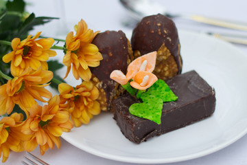 plate with chocolate cookies and flowers