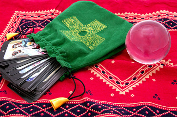 Tarot cards in green pouch  and crystal ball