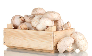 fresh mushrooms in a wooden box isolated on white