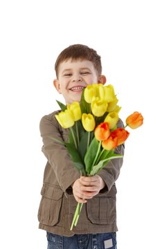 Little boy giving flowers smiling