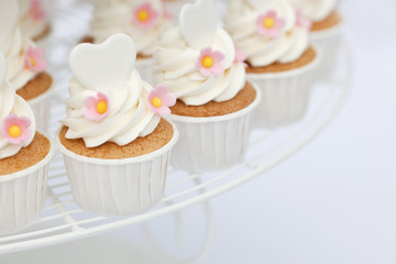 Heart shape decoration on cupcakes with shallow focus