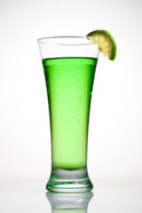 Green cocktail with a slice of lime
