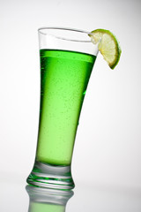 Green cocktail with a slice of lime