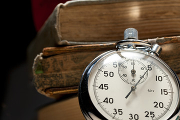 Pile of old books and stopwatch