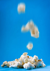 Obraz na płótnie Canvas Popcorn on the blue background