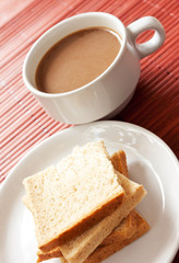 A cup of white coffee and bread