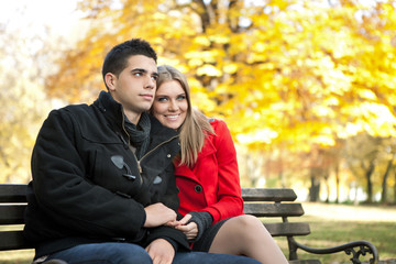 young couple sitting on bench