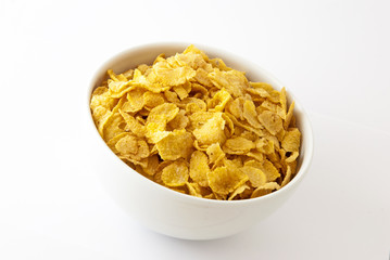 Cornflakes in bowl on white background