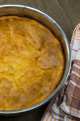 Home made baked cake in a springform on a wooden table