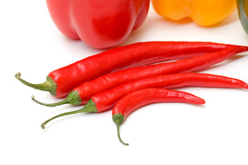 Chili pepper and paprika on white background
