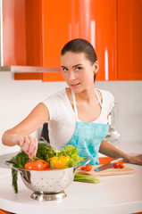 Beautiful young woman cooking in the kitchen