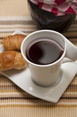 Tea, mini croissants and jam jar