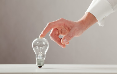 hand touches the lamp with your finger from the top